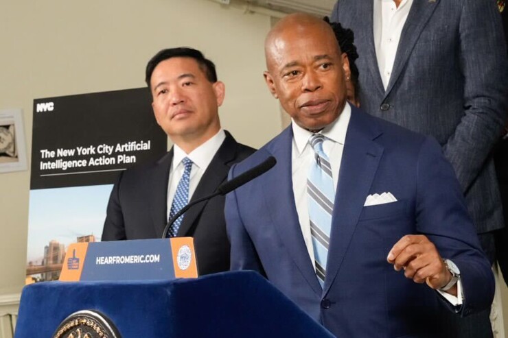 New York Mayor Eric Adams, foreground, announces the city's plan to use and manage artificial intelligence on Oct. 16.