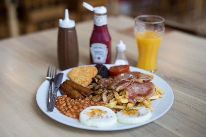 Sausages, eggs, baked beans, hash browns, orange juice, coffee, ketchup: The 'Super' full English breakfast sits at the 'Enough to Feed an Elephant' cafe in this arranged photograph in London, on July 10, 2017