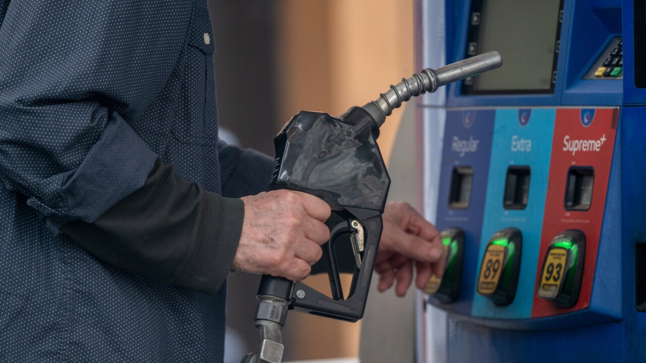A driver refuels a vehicle with unleaded gasoline at a Mobil gas station in New York