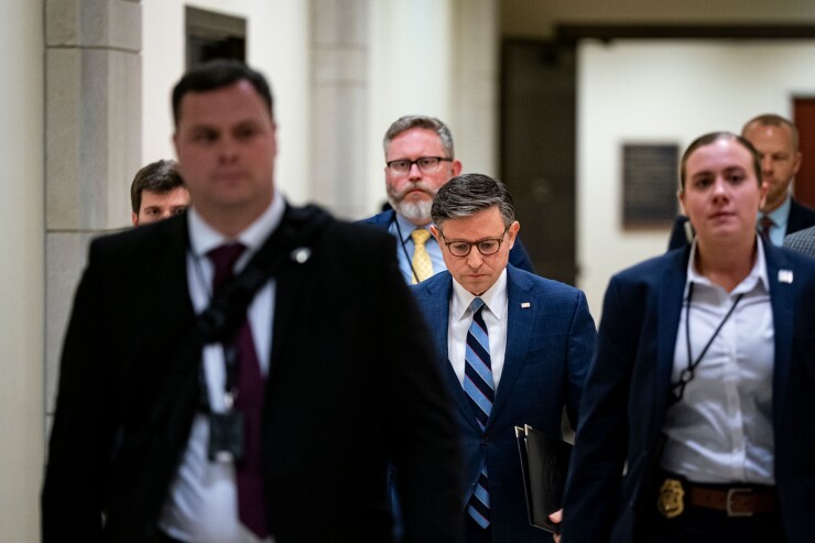 House Speaker Mike Johnson, a Republican from Louisiana, center, arrives for a news conference at the U.S. Capitol.