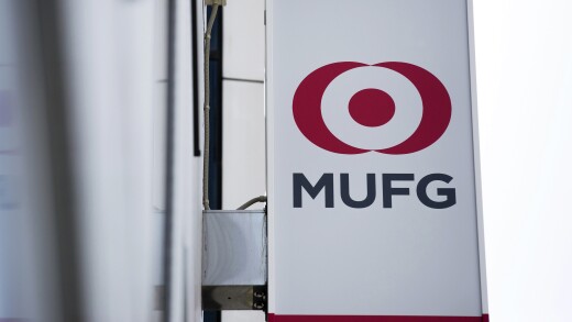 The logo of Mitsubishi UFJ Financial Group (MUFG) is displayed on a sign outside a Bank of Tokyo-Mitsubishi branch in Tokyo.