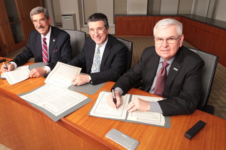 NASBA president and CEO Ken Bishop (left), ICAS CEO Anton Colella, and AICPA president and CEO Barry Melancon sign a mutual recognition agreement