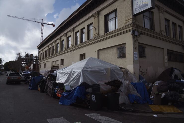 Homeless people in Los Angeles built a tarp tent ahead of storms