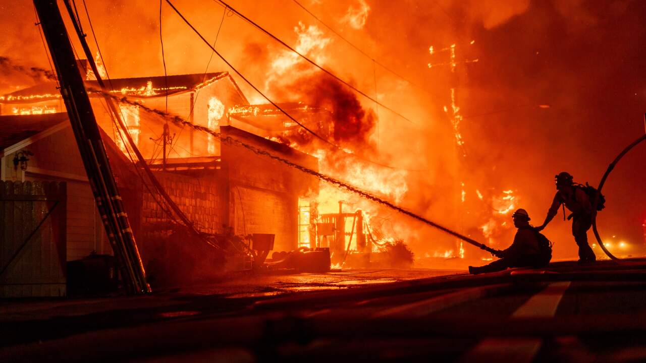 Firefighters battle flames during the Palisades Fire in Los Angeles on Jan. 7, 2025.