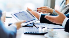 Image of hands pointing at touchscreen