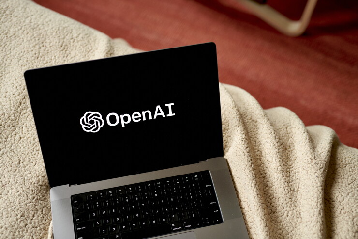 A picture of a computer with the OpenAI logo on the screen.