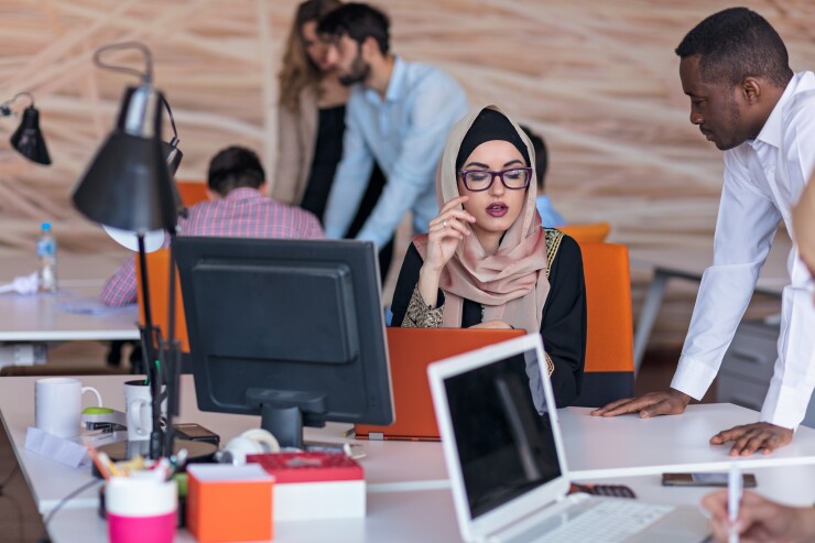 Woman in a headscarf working at an office