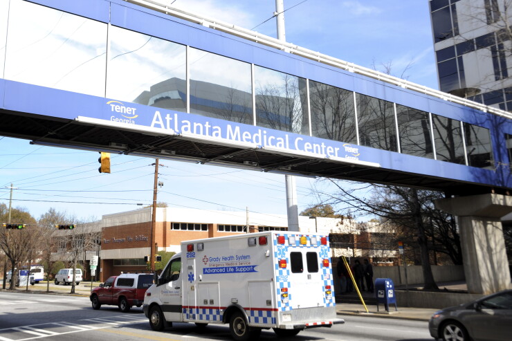 Ambulance passing under a medical center overpass in Atlanta.