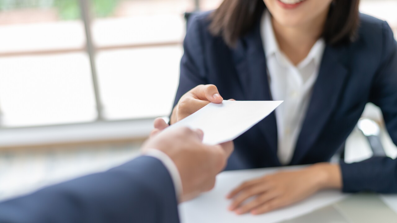 Young Asian business woman receiving salary or bonus money from