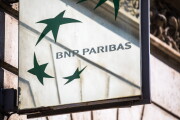 A BNP Paribas logo sits on a sign outside a bank branch in Paris.