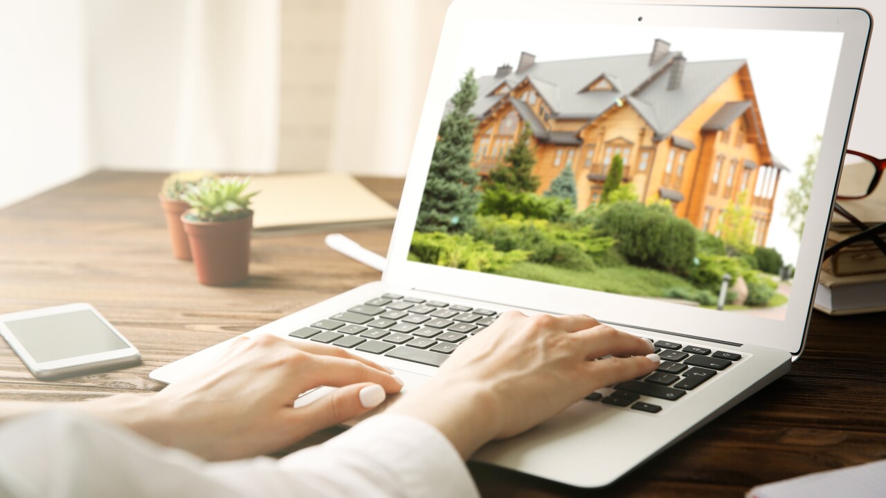 Online shopping concept. Woman looking for house on real estate market website