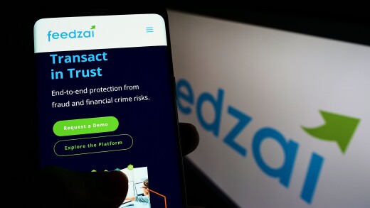 Stuttgart, Germany - 04-03-2022: Person holding smartphone with website of Portuguese risk management company Feedzai on screen in front of logo. Focus on center of phone display.