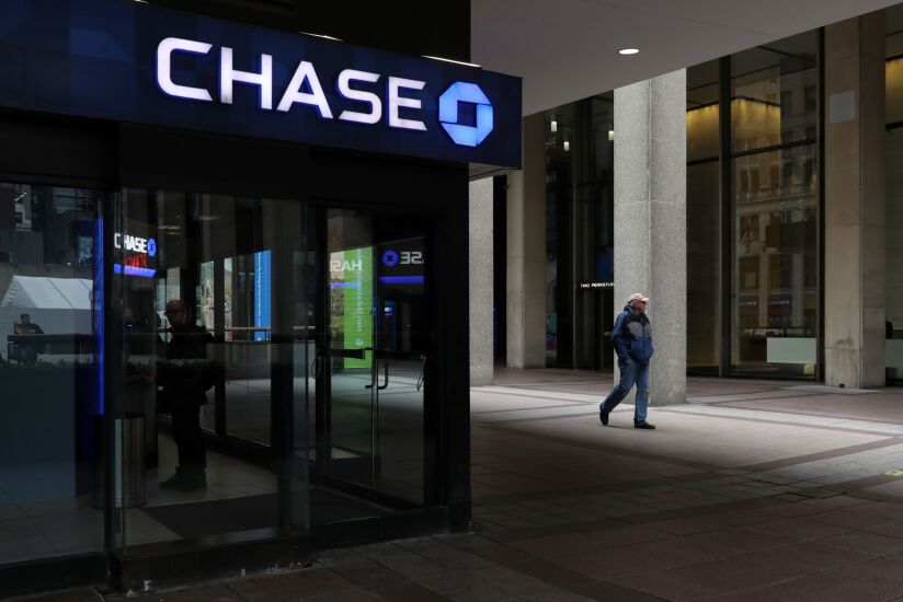 A pedestrian passes in front of a JPMorgan Chase bank branch outside Pennsylvania Station in New York Feb. 5, 2020. New York City has for decades talked about improving the neighborhood around antiquated Pennsylvania Station with the kind of development that's invigorated other parts of Manhattan. Real estate billionaire Steven Roth is finally seizing the moment. Photographer: Bess Adler/Bloomberg