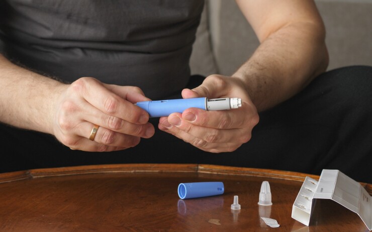 Man prepares semaglitude injection for weight loss and diabetes control