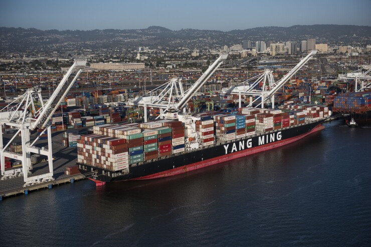 A Yang Ming Marine Transport Corp. container ship sits docked at the Port of Oakland in this aerial photograph taken above Oakland, California, U.S., on Monday, Oct. 5, 2015