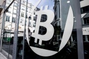 A logo sits on the windows of the offices of La Maison du Bitcoin bank in Paris, France.