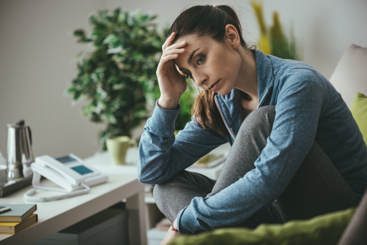 Woman looking upset while sitting at her desk
