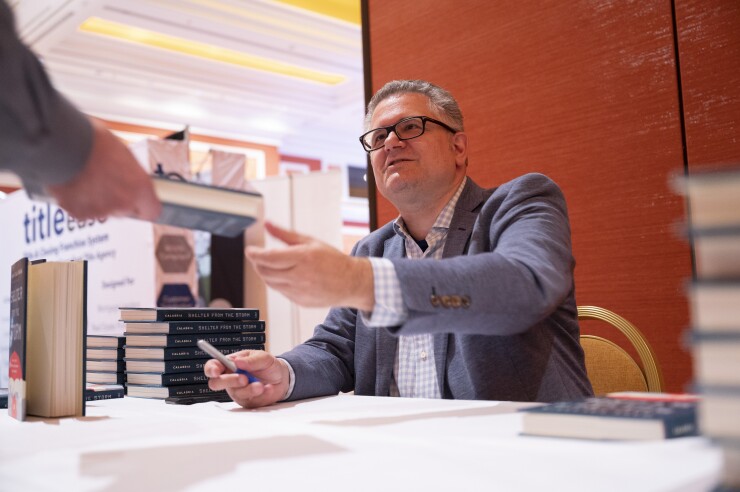 Former FHFA Director Mark Calabria signing books at the 2023 Digital Mortgage Conference. Photo credit: Jacob Kepler