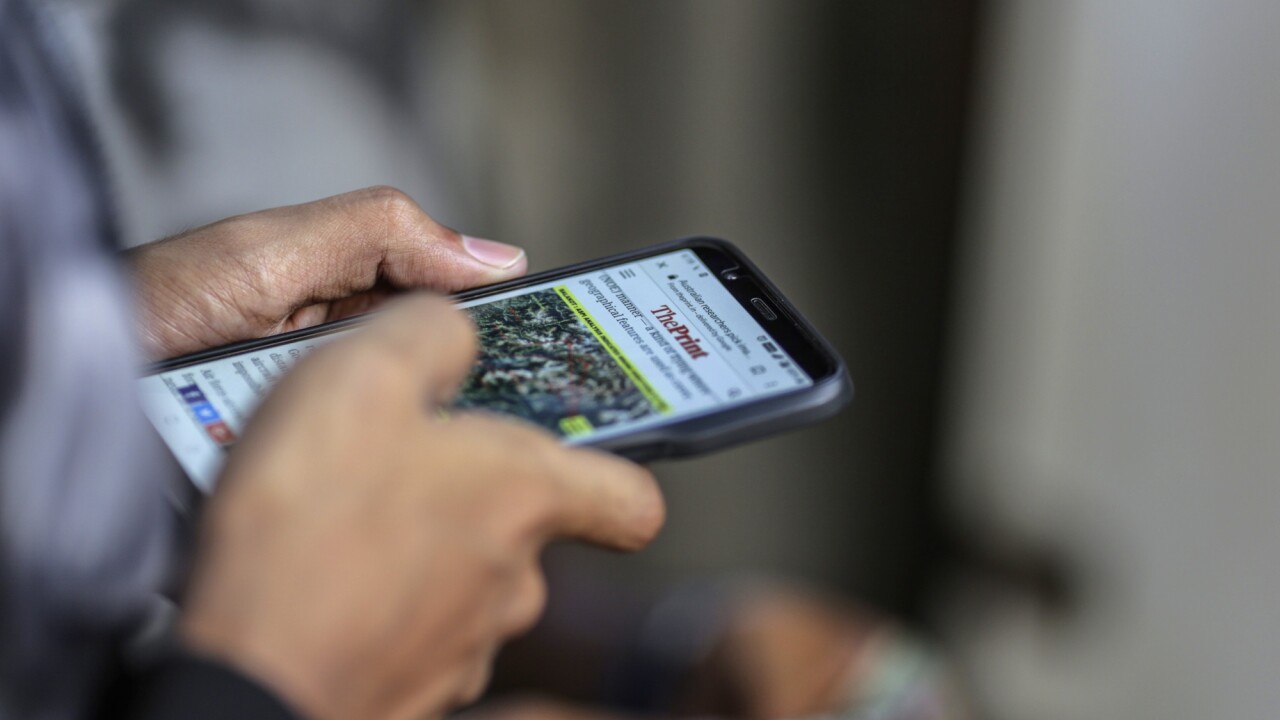 A man reads a news article on a smartphone in Mumbai, India, on Friday, March 28, 2019. Based on the early tallies, as many as 60 percent of India’s 900 million eligible voters are expected to cast ballots between now and May 19, as the center-left Congress Party tries to seize power from the right-wing Bharatiya Janata Party. As in other elections around the world, paid hacks and party zealots are churning out propaganda on Facebook Inc. and the company's WhatsApp messenger, along with Twitter, YouTube, TikTok, and other ubiquitous communication channels. Photographer: Dhiraj Singh/Bloomberg