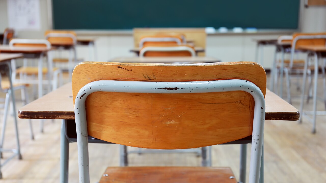 An empty chair in a classroom