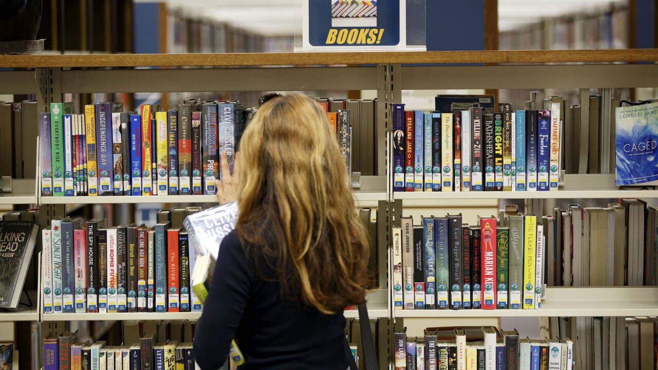 Books - Girl in library by Bloomberg News