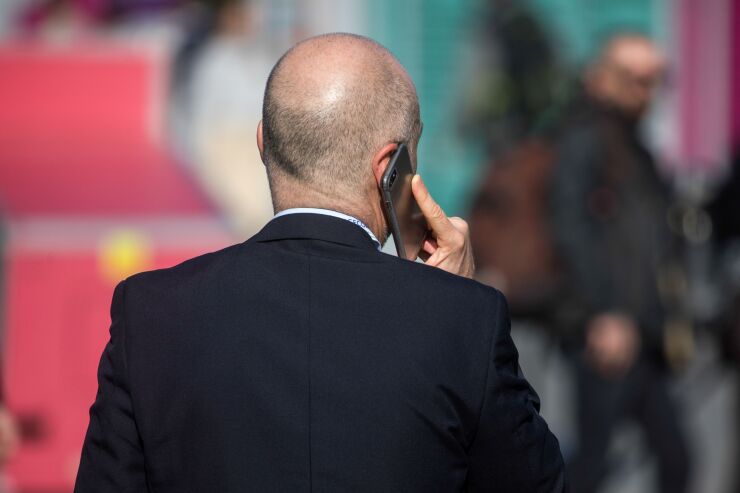 cell-phone-talking-business-suit-bloomberg-022321