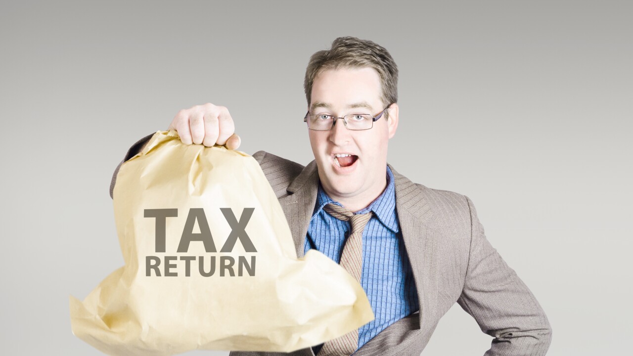 Accountant holding a large tax return refund bag