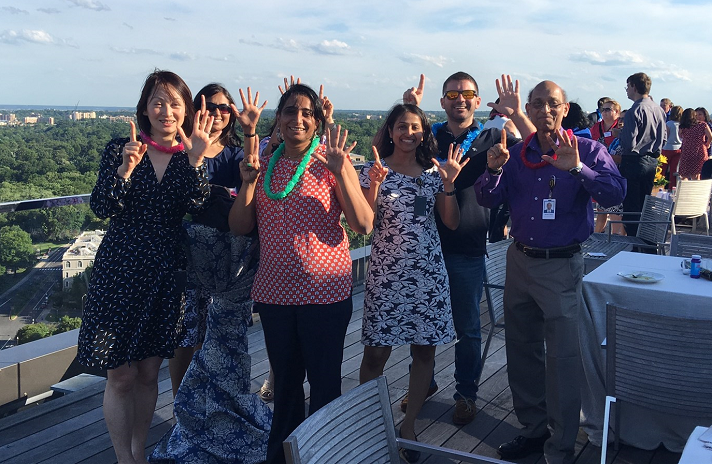 Promontory Interfinancial Network employees celebrate at a rooftop event.