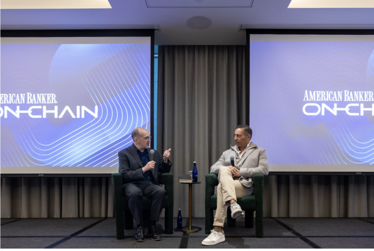 A picture of Coinbase's Brett Tejpaul and American Banker's Paul Vigna onstage.