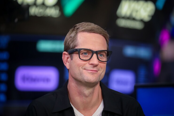 Close up of Klarna CEO Sebastian Siemiatkowski wearing glasses.