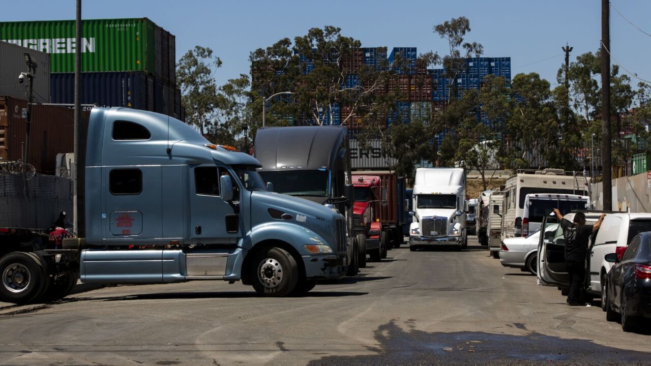 Semi-trucks lined up on a residential street in the Wilmington neighborhood of Los Angeles, California, US, on Tuesday, July 12, 2022. The worst of the supply-chain crisis may be over, but the problems haven't gone away for the neighborhood surrounding the US's busiest ports near Los Angeles. Photographer: Alisha Jucevic/Bloomberg
