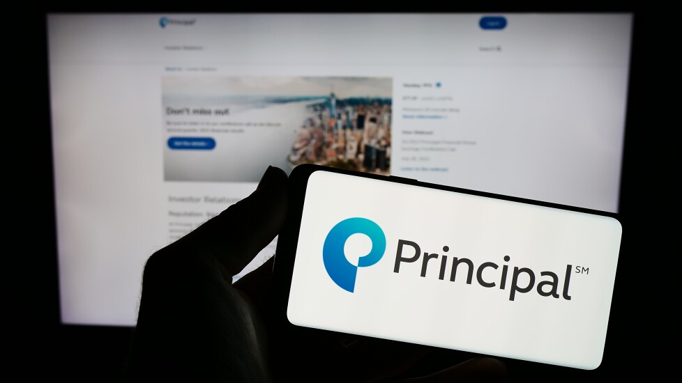 Stuttgart, Germany - 08-14-2023: Person holding smartphone with logo of US company Principal Financial Group Inc. on screen in front of website. Focus on phone display.