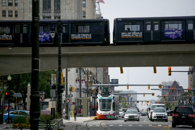 A Detroit People Mover (DPM) fully automated light rail train travels above a QLine Woodward Avenue streetcar in Detroit, Michigan, U.S., on Tuesday, Aug. 14, 2018.