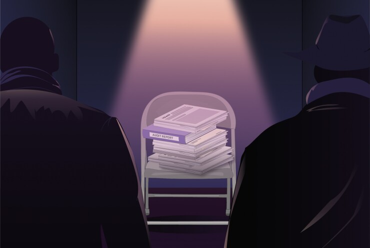 Tax returns and audit reports in a spotlight in an interrogation room