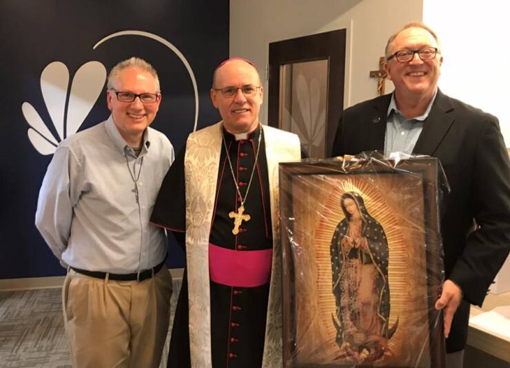 Fr. Kevin Bauman of South Bend, Ind.’s Our Lady of Hungary Parish (left) presents a photo of Our Lady of Guadalupe to Notre Dame Federal Credit Union president and CEO Tom Gryp with the Most Reverend Bishop Kevin Rhoads of the Diocese of Fort Wayne-South Bend, who blessed the credit union’s newest branch on Western Avenue.