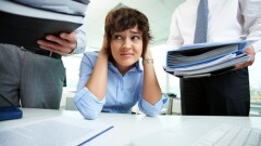 Office lady being scared because of too much paperwork to do