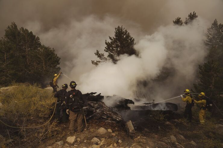 Firefighters work on a spot fire during the Caldor Fire in Kirkwood, California, U.S., on Friday, Sept. 3, 2021. The Caldor Fire, which ignited Aug. 14 has burned at least 212,907 acres, or more than 332 square miles, and containment stood at 29% as of Friday, Cal Fire said in its morning update. Photographer: Eric Thayer/Bloomberg