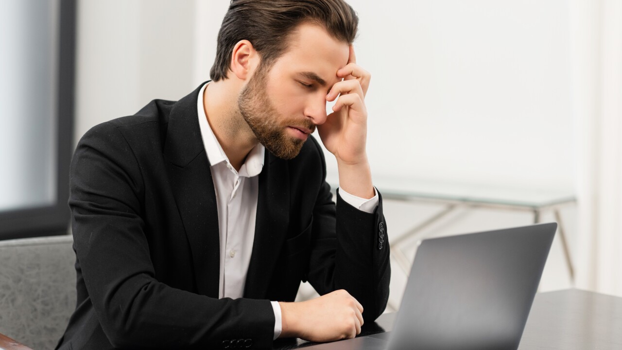 Employee with head in hand