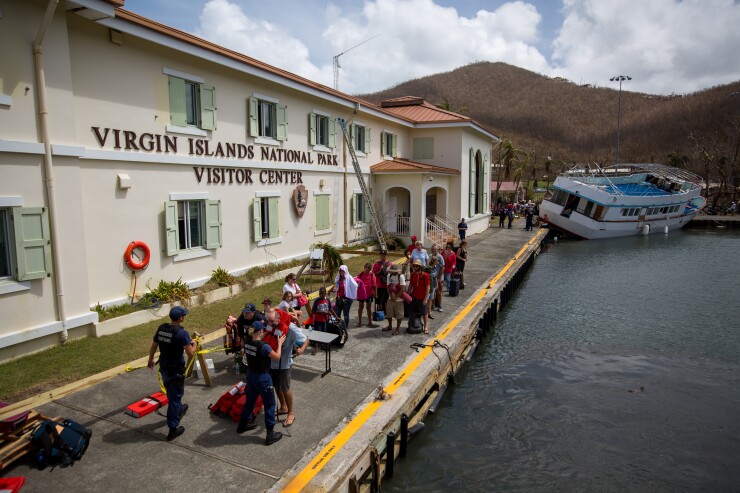 Members of the U.S. Coast Guard process evacuees after Hurricane Irma in St John, U.S. Virgin Islands, on Tuesday, Sept. 12, 2017.
