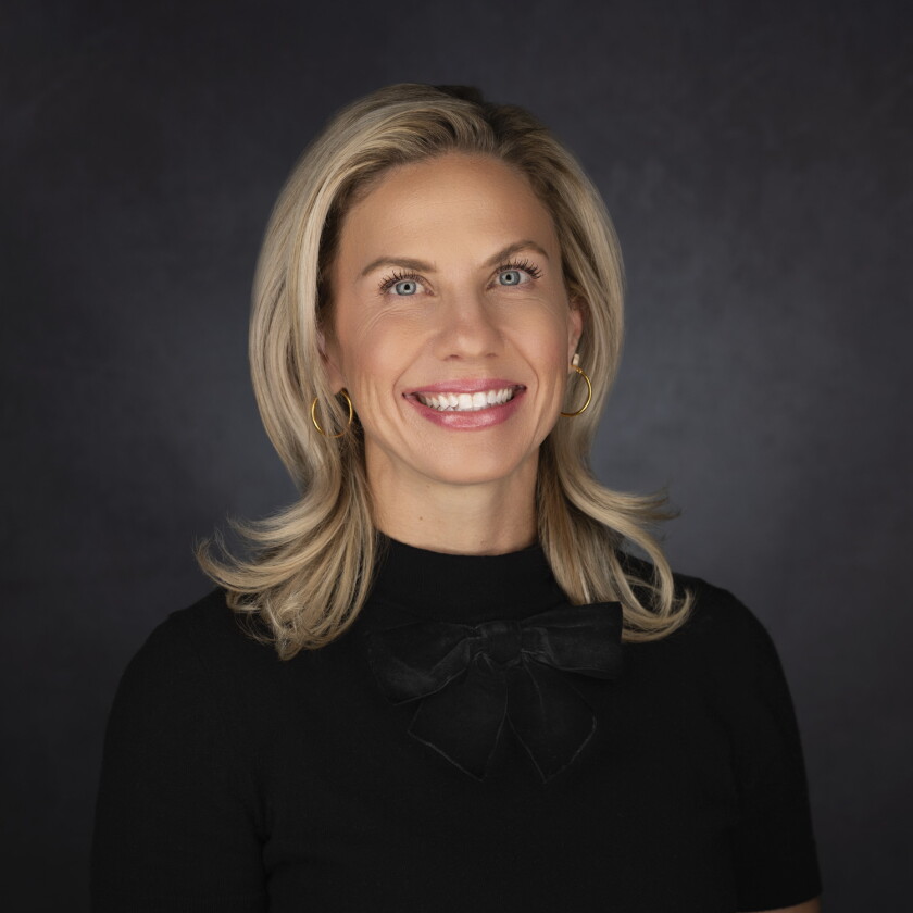 A woman smiling for a portrait photo.