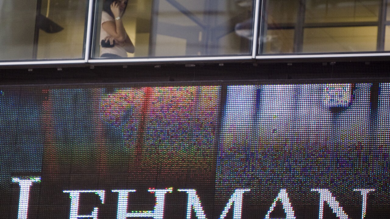 A woman talks on a cell phone inside the headquarters of Lehman Brothers Holdings Inc., in New York, U.S., on Sept. 15, 2008. Two weeks after Lehman Brothers' bankruptcy triggered a global credit crisis, Morgan Stanley countered concerns that it might be next to go by announcing it had “strong capital and liquidity positions.†Photographer: Jeremy Bales/Bloomberg