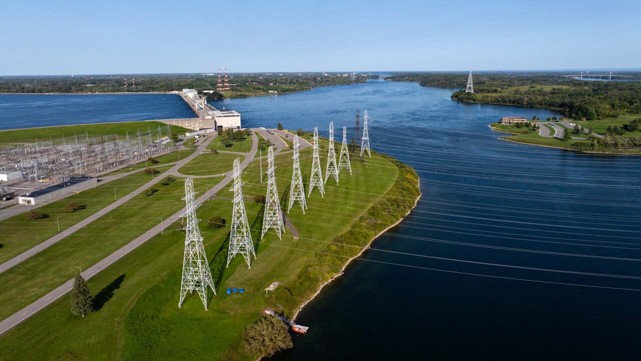Electricity transmission lines in front of a dam