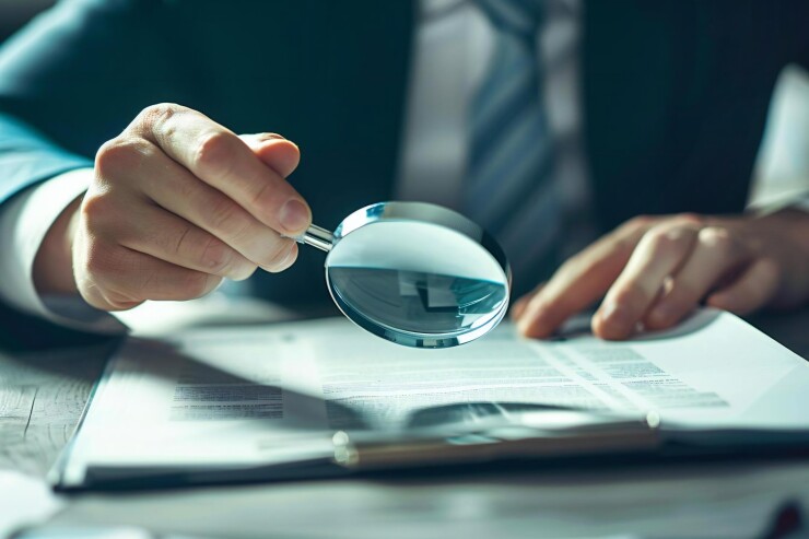 Corporate auditor investigates fraud in business document inspection