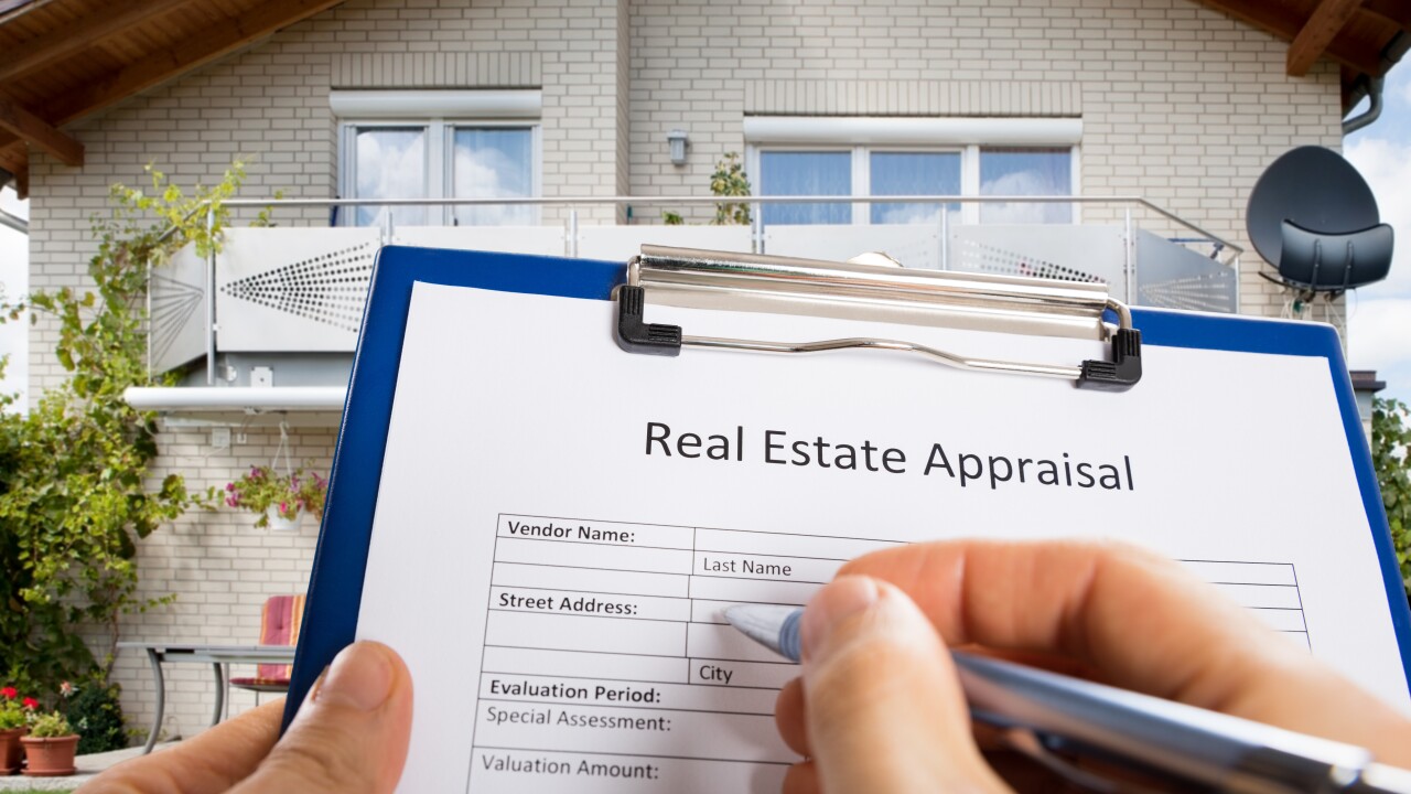 Person Hand Filling Real Estate Appraisal Document