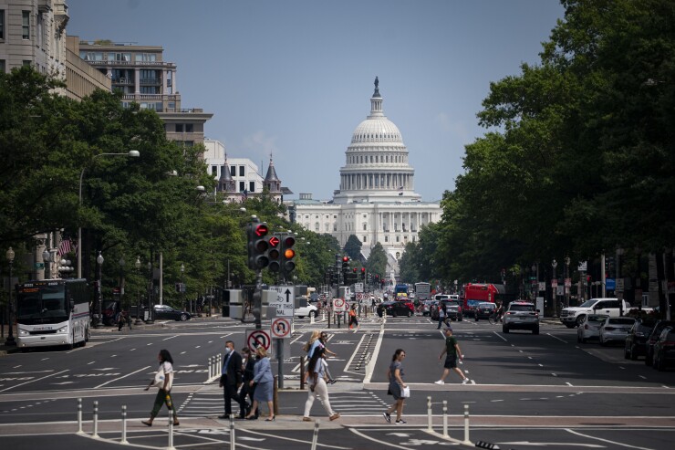 Pedestrians cross a street near the U.S. Capitol in Washington, D.C.