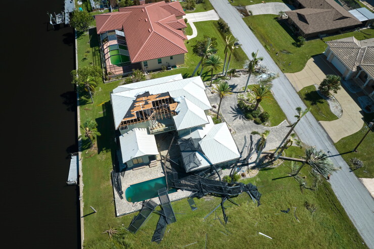 Hurricane Ian destroyed house in Florida residential area.