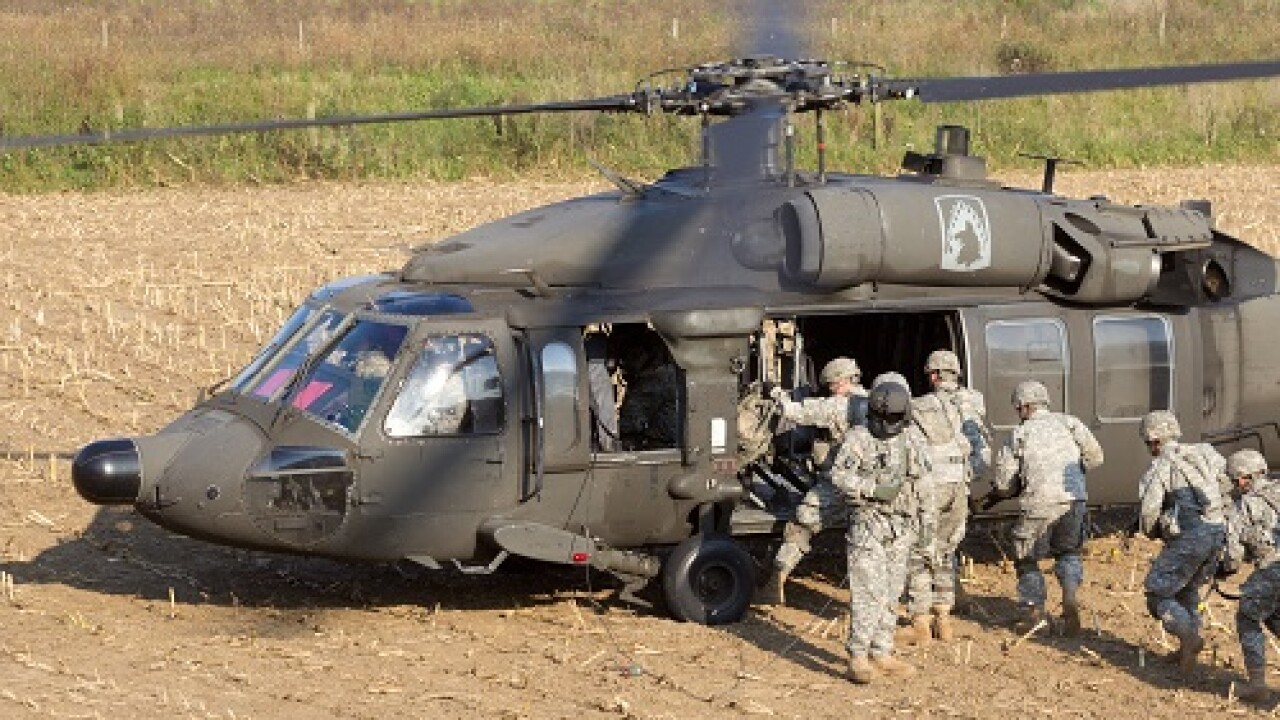 GRAVE, NETHERLANDS - SEP 17: Soldiers of the 82nd Airborne Division enter a Black Hawk helicopter at the Operation Market Garden memorial on Sep 17, 2014 Grave, Netherlands. Market Garden was a large Allied operation in 1944.