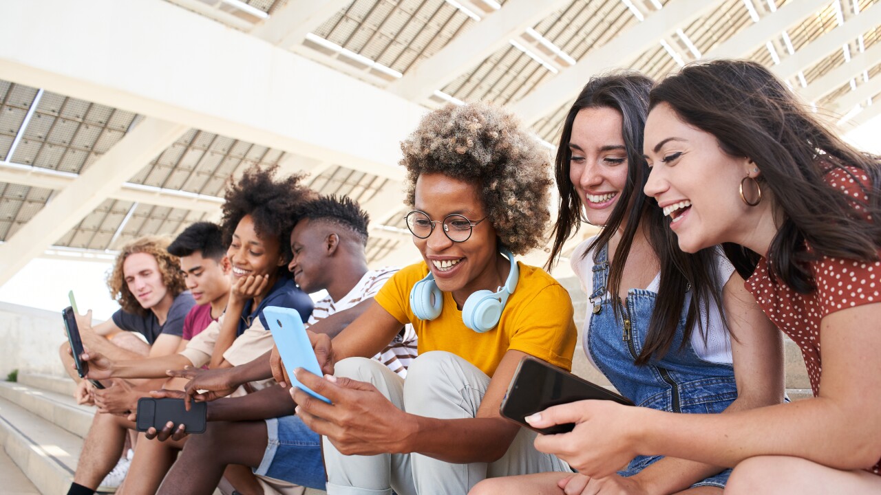 College students looking at their phones