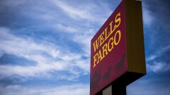 Blue Sky. Signage stands outside a Wells Fargo & Co. bank branch in Evanston, Illinois, U.S., on Tuesday, July 10, 2018. Wells Fargo & Co. is scheduled to release earnings figures on July 13. 