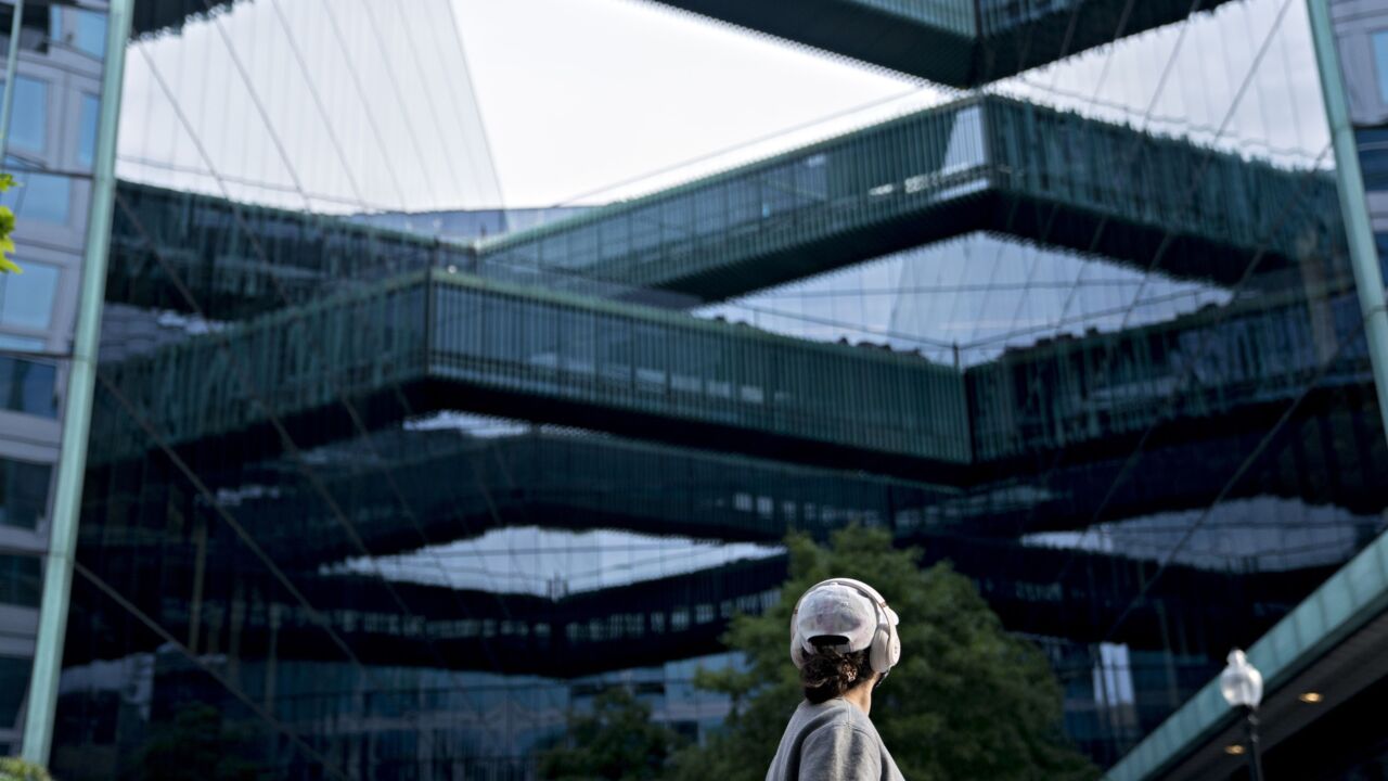 A pedestrian walks near the building that houses the Fannie Mae headquarters in Washington on May 8, 2020.
